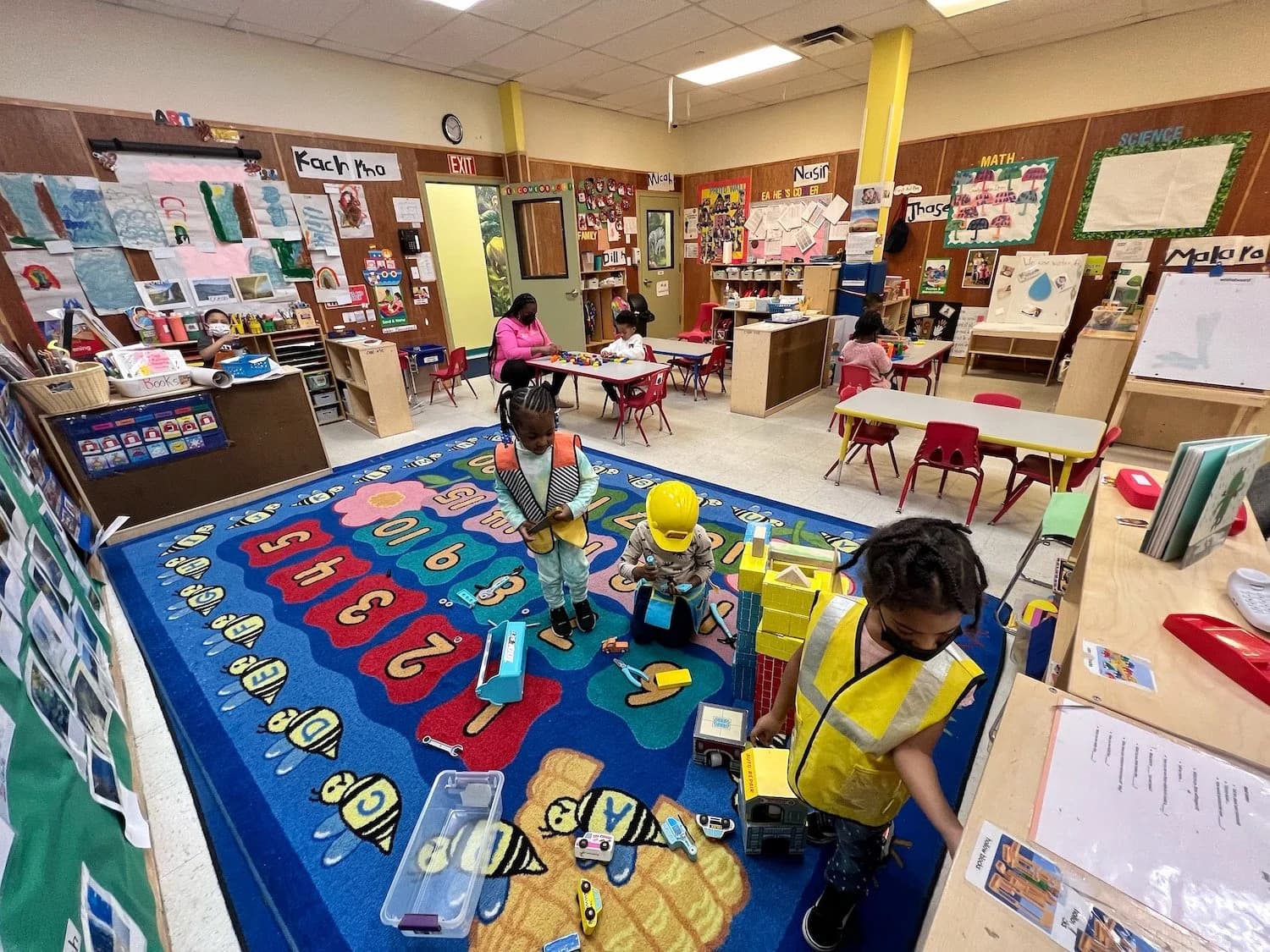 Children engaged in learning activities at Einstein Daycare classroom in Brooklyn