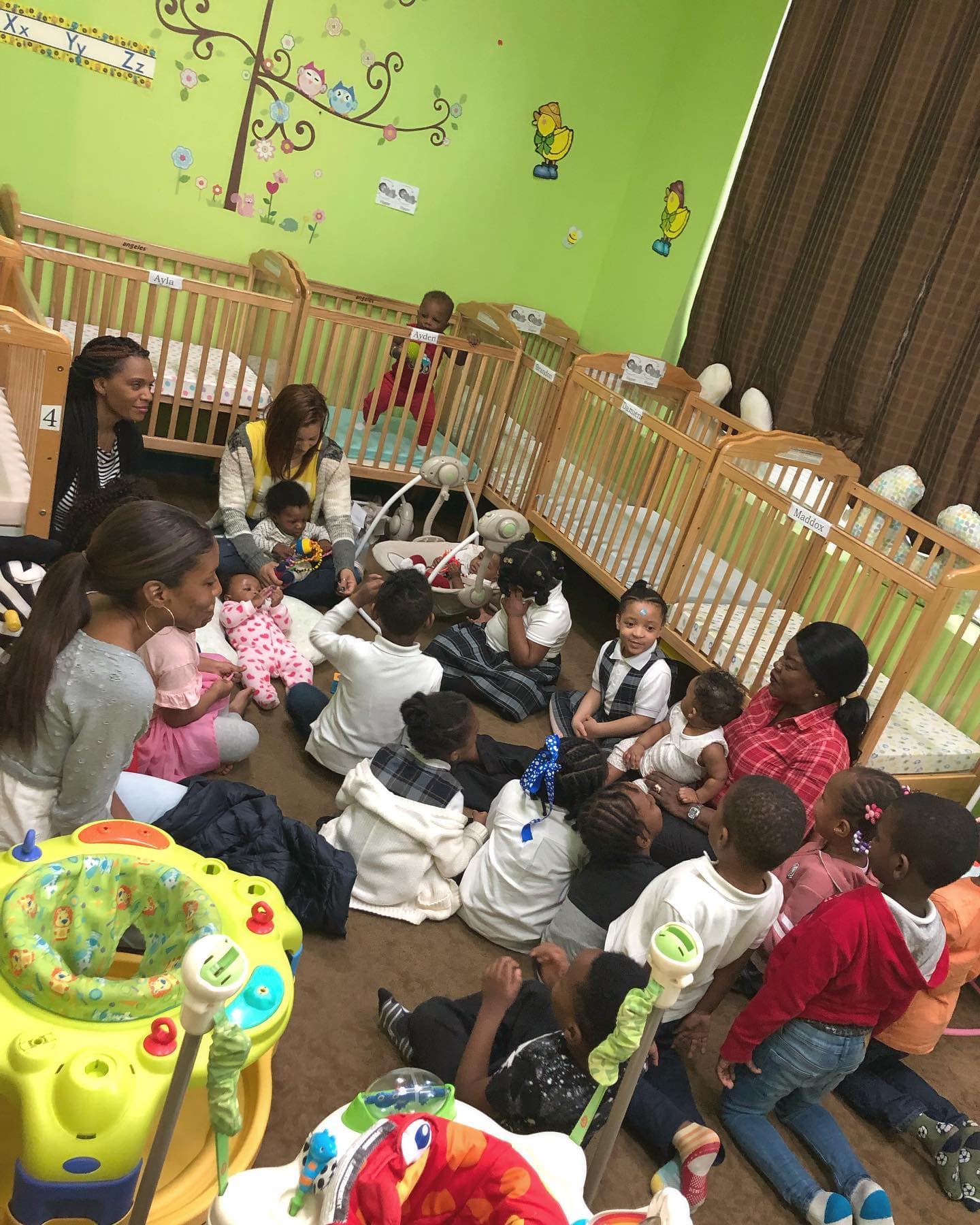 Caregivers with infants and toddlers in the Einstein Daycare infant classroom